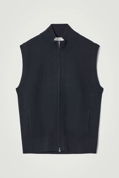 Offering endless layering potential, this navy tank is cut in a relaxed shape and closes with a double-ended zip. It's rib-knitted from an RWS wool blend and designed with a pair of side-seam pockets and a funnel neck for added warmth. Relaxed fitTwo-way zip closureThis product contains Responsible Wool Standard TE-00047206 (RWS) wool fiber from farms certified to animal welfare and land-management requirements  Shell: 63% RWS Wool, 37% Cotton. Excluding trims / Machine wash Back length of size M is 25" / Model wears a size M Belted Cape, Latest Clothes For Men, Half Zip Jumper, Land Management, Tapered Leg Jeans, Denim T Shirt, Women Magazines, Outerwear Vest, Wool Vest