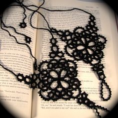 an open book with some black beads on it