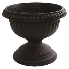 a large black planter sitting on top of a table