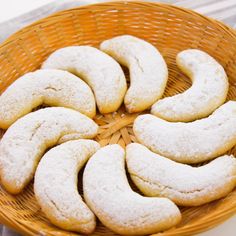 powdered sugar cookies in a basket on a table