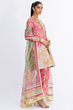 This short, aurora pink angarkha is the embodiment of a classy yet charming festive look. It is rendered with a thoughtful arrangement of zardoze and gota work on a floral-printed khaddi silk, featuring a chatapatti border. A multi-coloured dupatta with gota finishing and a printed shalwar add the final touches to this Suits Indian, Gota Work, Women Suits, A Line Kurta, Desi Style, Festive Look, Website Features, Silk Organza, Wedding Outfits