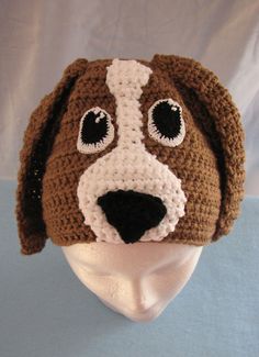 a brown and white dog hat on top of a mannequin's head