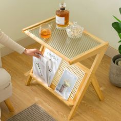 a woman is reading a magazine on a small table