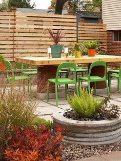 an outdoor dining area with green chairs and plants