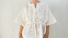 White Chikankari Embroidery Kaftan Tunic, White Tunic Kaftan With Chikankari Embroidery, White Chikankari Embroidery Summer Tunic, White Chikankari Embroidery Kaftan For Vacation, White Cotton Tunic Kaftan, White Cotton Kaftan With Chikankari Embroidery, Elegant White Kaftan For Daywear, Casual White Short Sleeve Kaftan, White Chikankari Embroidery Kaftan For Beach