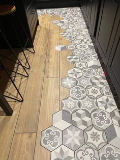 the kitchen floor is covered in grey and white tiles