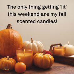 candles and pumpkins on a table with the words, the only thing getting lit this weekend are my fall scented candles