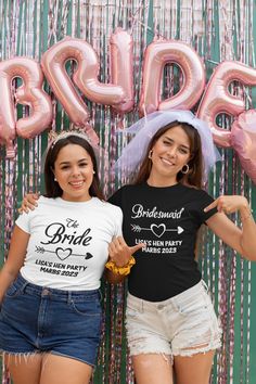 two young women standing next to each other in front of balloons