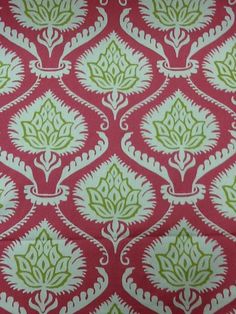 a red and green fabric with white designs on it