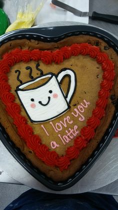 there is a heart shaped cake with a coffee cup on it