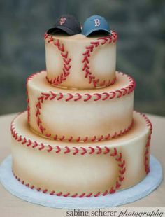 a three tiered cake with baseball themed frosting