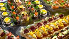 an assortment of appetizers are displayed on trays