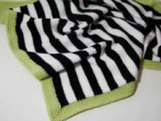 a black and white striped scarf laying on top of a table