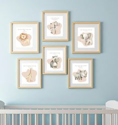 a baby's nursery room with blue walls and pictures on the wall, including an elephant