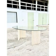 a glass table sitting in front of a building