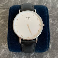 Daniel Wellington Women's 0960dw Classy St Mawes Stainless Steel Watch With Crystal Markers About This Item Round Watch Featuring Logoed White Dial With Crystal Indices 34 Mm Stainless Steel Case With Mineral Dial Window Quartz Movement With Analog Display Leather Calfskin Band With Buckle Closure Water Resistant To 30 M (100 Ft): In General, Withstands Splashes Or Brief Immersion In Water, But Not Suitable For Swimming. Classic White Watch With Leather Strap, Luxury White Watch For Everyday Wear, Luxury White Watch For Everyday, Luxury White Watches For Everyday, Formal White Leather Strap For Watches, Classic White Gold Watch With Adjustable Band, Classic White Watch Accessories For Everyday Use, Classic White Watch For Work, Classic White Watch Accessories For Everyday