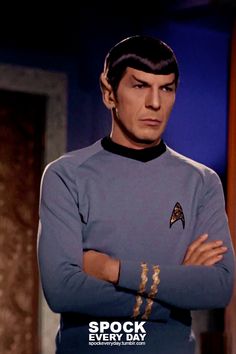 star trek's spock is standing with his arms crossed in front of him