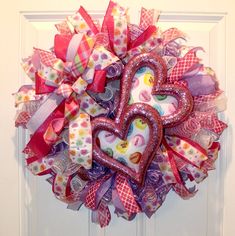 a heart shaped wreath hanging on the front door