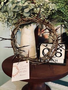 a table with a wreath and some cards on it