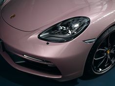 the front end of a pink sports car