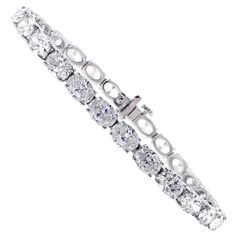 From Pampillonia jewelers, 27 perfectly matched oval diamonds lined up end to end form a straight line of diamonds. The 27 diamonds weigh 11.50 carats and are E-F color and are VS2+ clarity, set in 18 karat white gold. The bracelet is 6 ¾ inches and is available in any length. Pampillonia custom creates diamond bracelets in a variety of diamond shapes and sizes Luxury Oval Tennis Bracelet In Fine Jewelry Style, Luxury Oval Cubic Zirconia Bracelet, Oval Bracelet Diamond, Oval Diamond Bracelet With 17 Jewels, Formal Oval Diamond Bracelet With Single Cut Diamonds, Luxury Oval Diamond Bracelet With Prong Setting, Luxury Diamond White Oval Diamond Bracelet, Luxury Oval Diamond White Diamond Bracelet, Oval Diamond Cut Tennis Bracelet