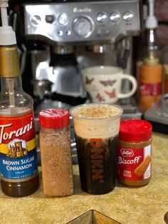 spices and seasonings are on the counter next to an espresso coffee maker