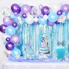 a table with balloons, cake and decorations for a frozen princess birthday party on it