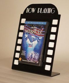 a movie poster holder with a dvd on it