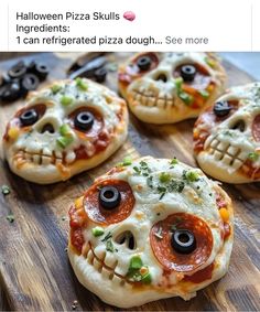 four pizzas with eyes on them sitting on top of a wooden cutting board