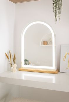 boho inspired LED arch vanity mirror on a white vanity tabletop Boho Minimalist Vanity, Vanity With Light Up Mirror, Bedroom Vanity Lighting Ideas, Vanity Light Over Arch Mirror, Light Up Vanity Mirror Aesthetic, Makeup Light Mirror, Makeup Vanity Styling, Bedroom Vanity Mirror, Vintage Vanity Mirror With Lights