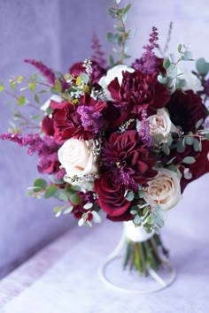 a bouquet of red and white flowers on a table