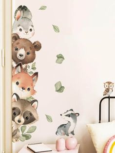 the wall decals in this children's room are painted with animals and leaves