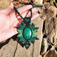 Unleash the vibrant energy of green malachite with this dynamic macrame pendant necklace! Elevate your style with a burst of color and intricate design. The pendant, standing at 10.5 cm (4.13 inches) in height and 7 cm (2.8 inches) in width, is a bold statement of artistry. Details: - Pendant Height: 10.5 cm (4.13 inches) - Pendant Width: 7 cm (2.8 inches) - Necklace Length: 56 cm (22 inches) at its smaller setting, with a sliding clasp for adjustable length. This handmade masterpiece is not just a necklace; it's an expression of individuality. The lush green malachite is perfectly complemented by the black macrame, creating a fusion of style and elegance. Key Features: - Dynamic Green Malachite - Adjustable Length with Sliding Clasp - Handcrafted with Precision - Vibrant and Bold Design P Green Macrame Necklace For Gift, Green Malachite Bohemian Jewelry, Bohemian Malachite Beaded Necklace, Spiritual Malachite Pendant Necklace, Nature Inspired Accessories, Green Malachite Spiritual Necklace, Macrame Pendant, Black Macrame, Malachite Necklace