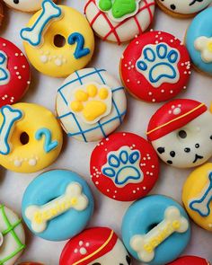 there are many decorated donuts with different designs on them, including dogs and bones