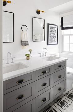 a bathroom with two sinks and mirrors on the wall