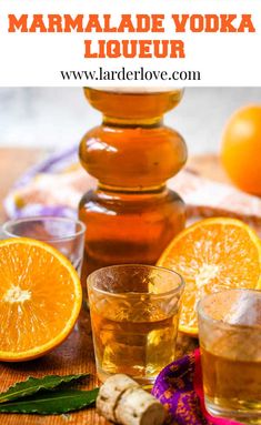 an orange juice in a glass next to some sliced oranges on a table with the words marmalade vodka liqueur