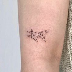 a small airplane tattoo on the right side of the leg, it is black and white