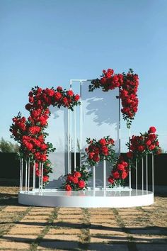 red roses are placed on the side of a white structure with metal bars and poles