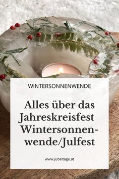 a candle that is sitting on top of a wooden table with the words winter in german