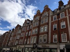 the building has many windows on it and is brown in color with white trims