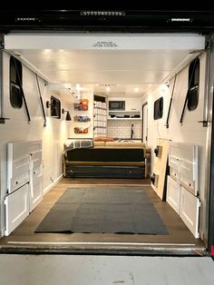 the interior of an rv with couches and refrigerators in it's door