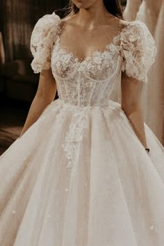 a woman in a wedding dress is looking down