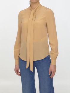 100% Silk | Saint Laurent Women's Bow Collar Plain Shirt in Beige | SS23 Classic Silk Tops For Fall, Designer Tops With Relaxed Fit For Formal Occasions, Spring Designer Office Tops, Classic Silk Tops With Relaxed Fit, Designer Spring Tops For Workwear, Designer Tops For Work In Fall, Designer Silk Tops For Fall, Luxury Relaxed Fit Workwear Tops, Luxury Relaxed Fit Tops For Work