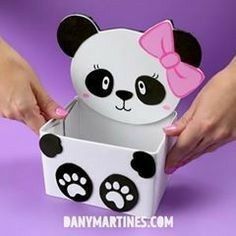 a person holding a panda bear shaped box