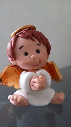 an angel figurine sitting on top of a table