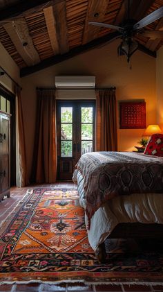 a bedroom with a large bed and two windows