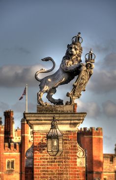 a lion statue on top of a brick building