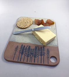 a cutting board with cheese and crackers on it