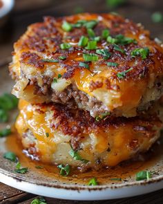 two cheeseburger patties stacked on top of each other with green onions and parsley