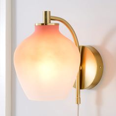 a light that is on the wall next to a white wall with a brown handle